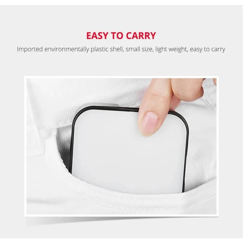 A hand is holding a small, square white clip-on LED light inside a white fabric pocket.