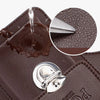 A close-up of a brown leather waist bag showing a dripping substance and a silver clasp.