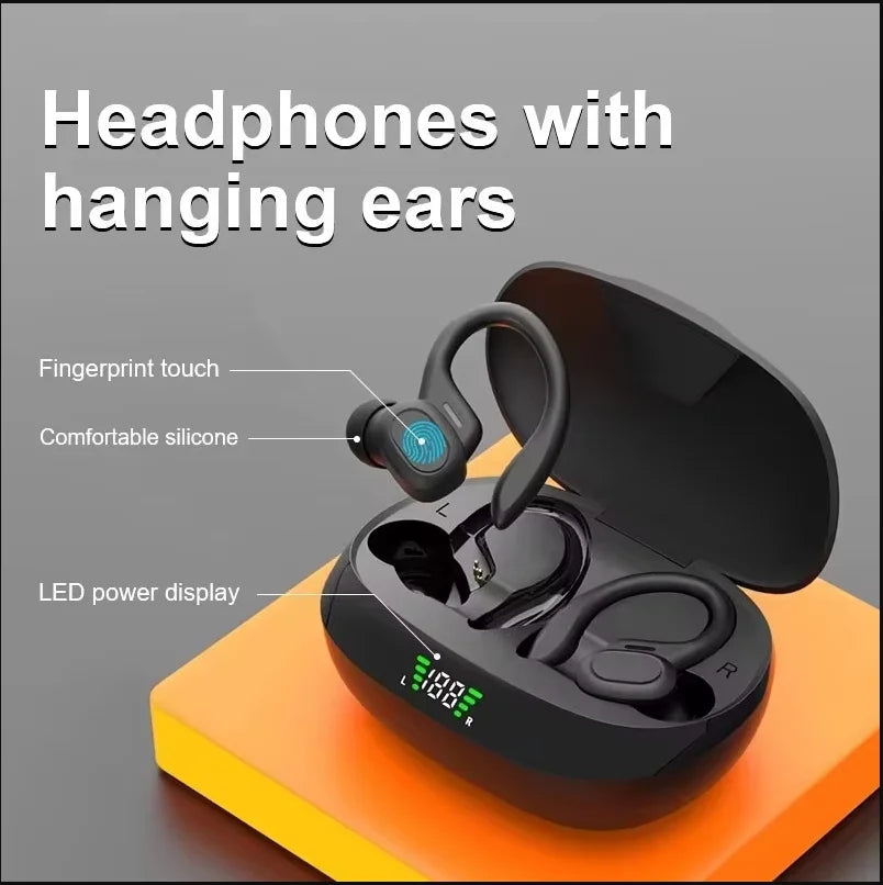 Black wireless Bluetooth earbuds with hanging ears displayed on an orange surface.