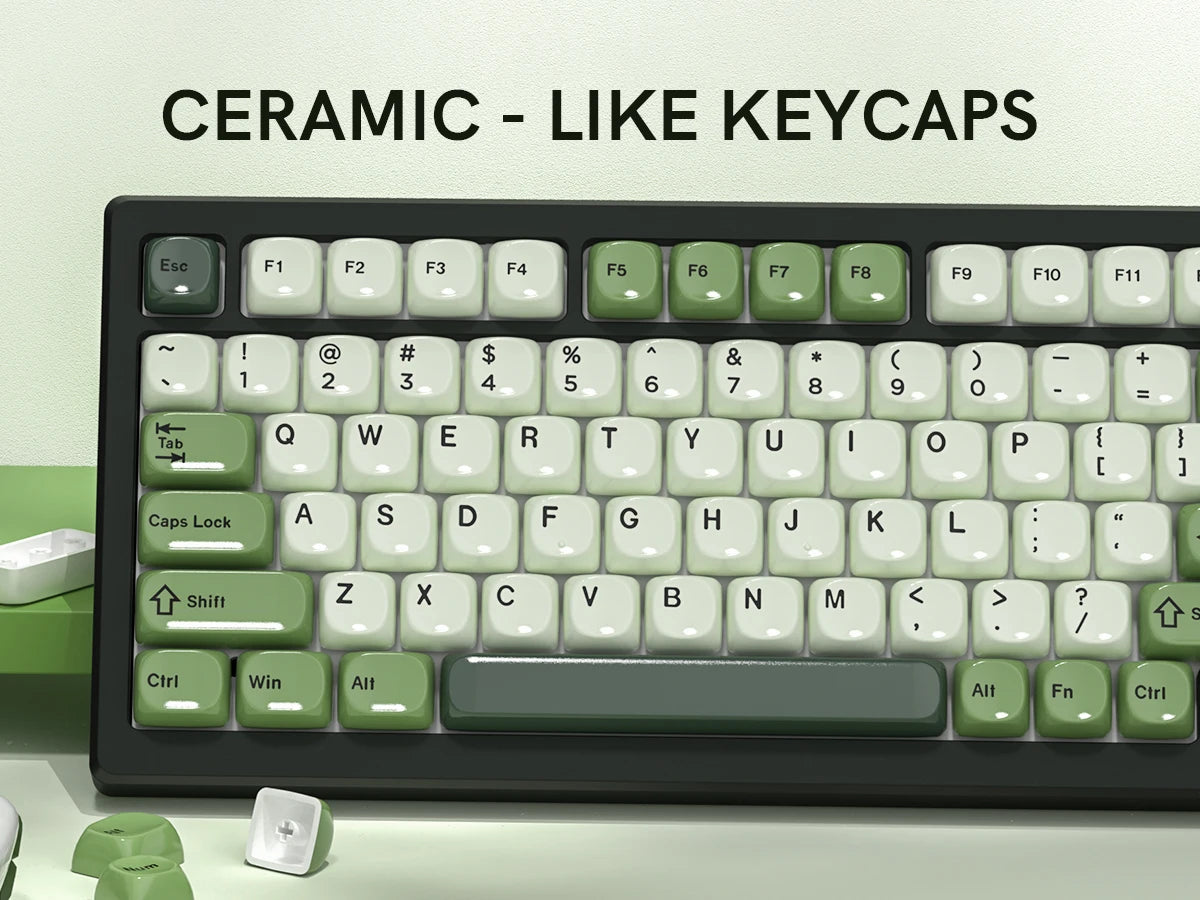 A close-up view of a black mechanical keyboard featuring bright green ceramic-like keycaps.