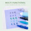 A collection of various colored pens and a sheet of graph paper are displayed, suitable for writing with multiple pens.