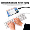 A hand is using a keyboard connected to a tablet via an OTG adapter for faster typing.