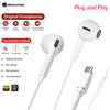 White plug and play earphones with a microphone shown next to a charging cable.