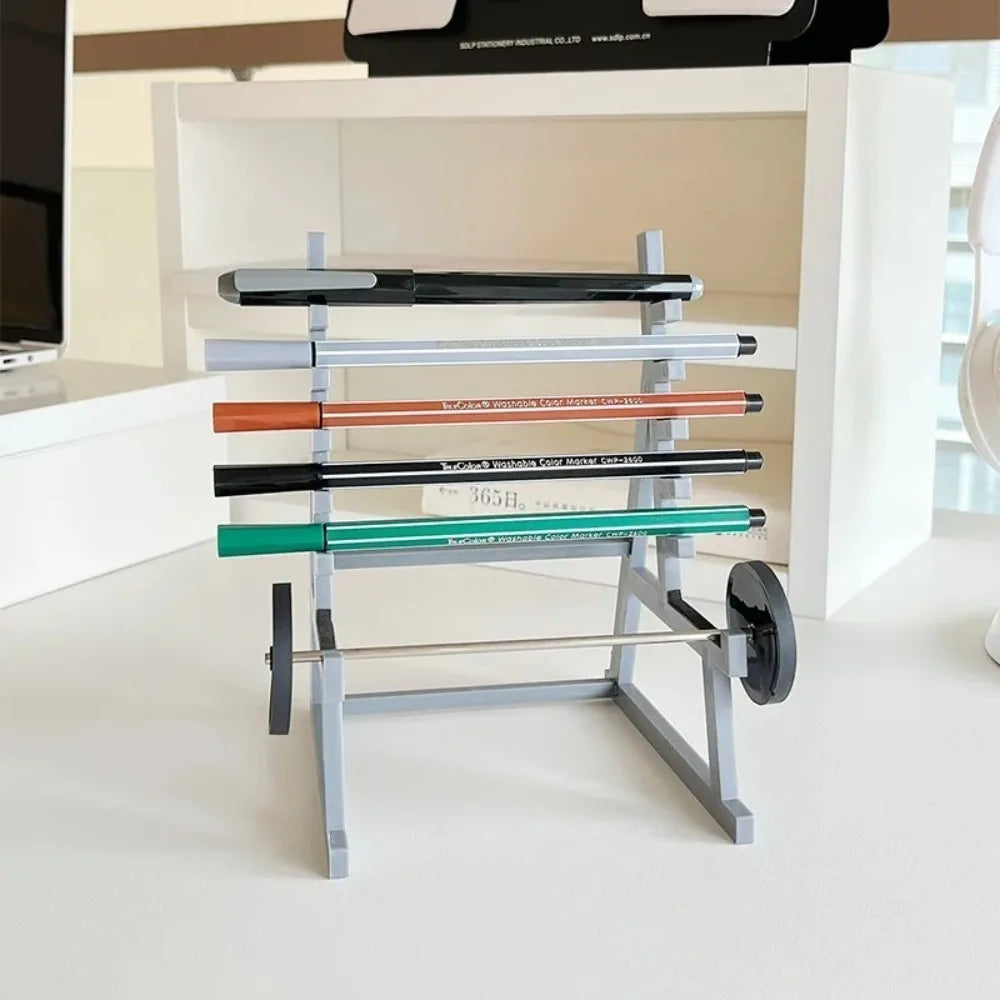A gray barbell rack organizer with multiple colored bars for holding pens or tools on a white desk.
