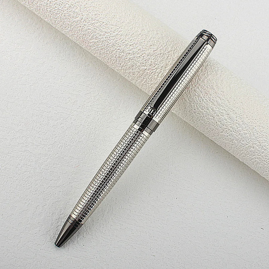 A silver metal ballpoint pen with a textured body is shown diagonally on a white surface.