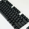 Vista cercana de teclas de contorno degradadas negras para teclado mecánico, mostrando el diseño y la textura.