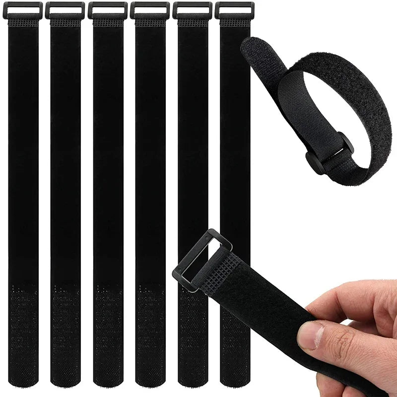 Black reusable hook and loop cable ties with a black strap shown being held by a hand