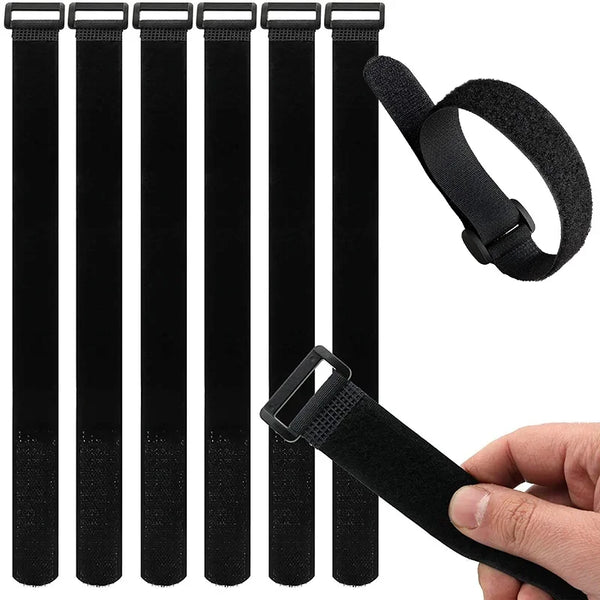Black reusable hook and loop cable ties with a black strap shown being held by a hand