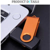 An orange USB flash drive is shown next to a white electronic device.