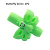 A single lime green silicone pencil grip shaped like a butterfly with a face.