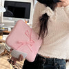 A person holds a pink ultra-thin laptop sleeve case for tablets and notebooks.