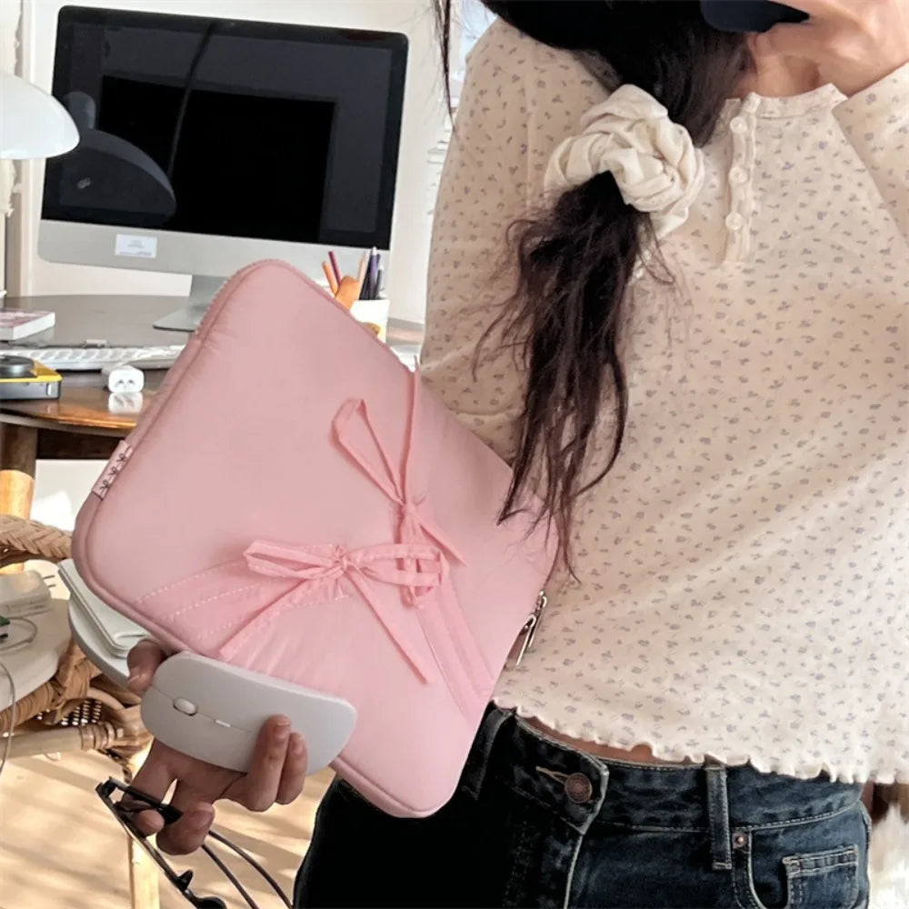 A person holds a pink ultra-thin laptop sleeve case for tablets and notebooks.
