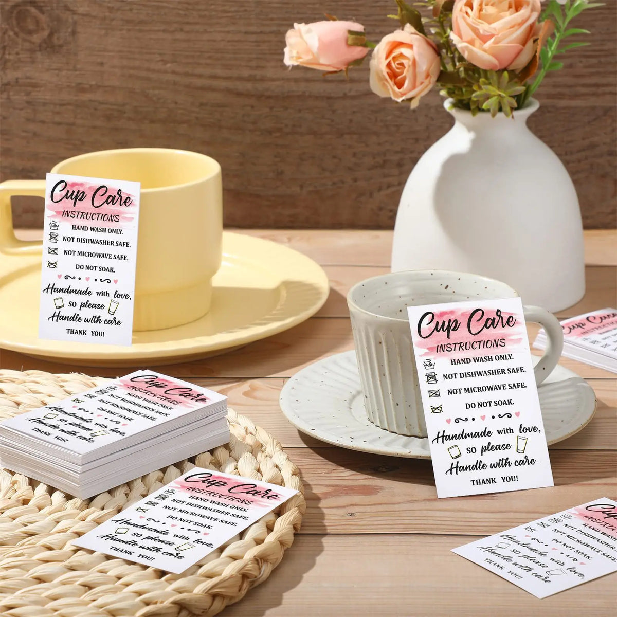 A collection of pink and white card instructions for cup care is displayed next to a ceramic mug and saucer.