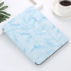 A light blue marble patterned skin for an iPad Pro placed on a white surface.