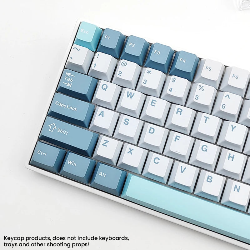A close-up view of a light blue and white keycap set for MX Mechanical keyboards.