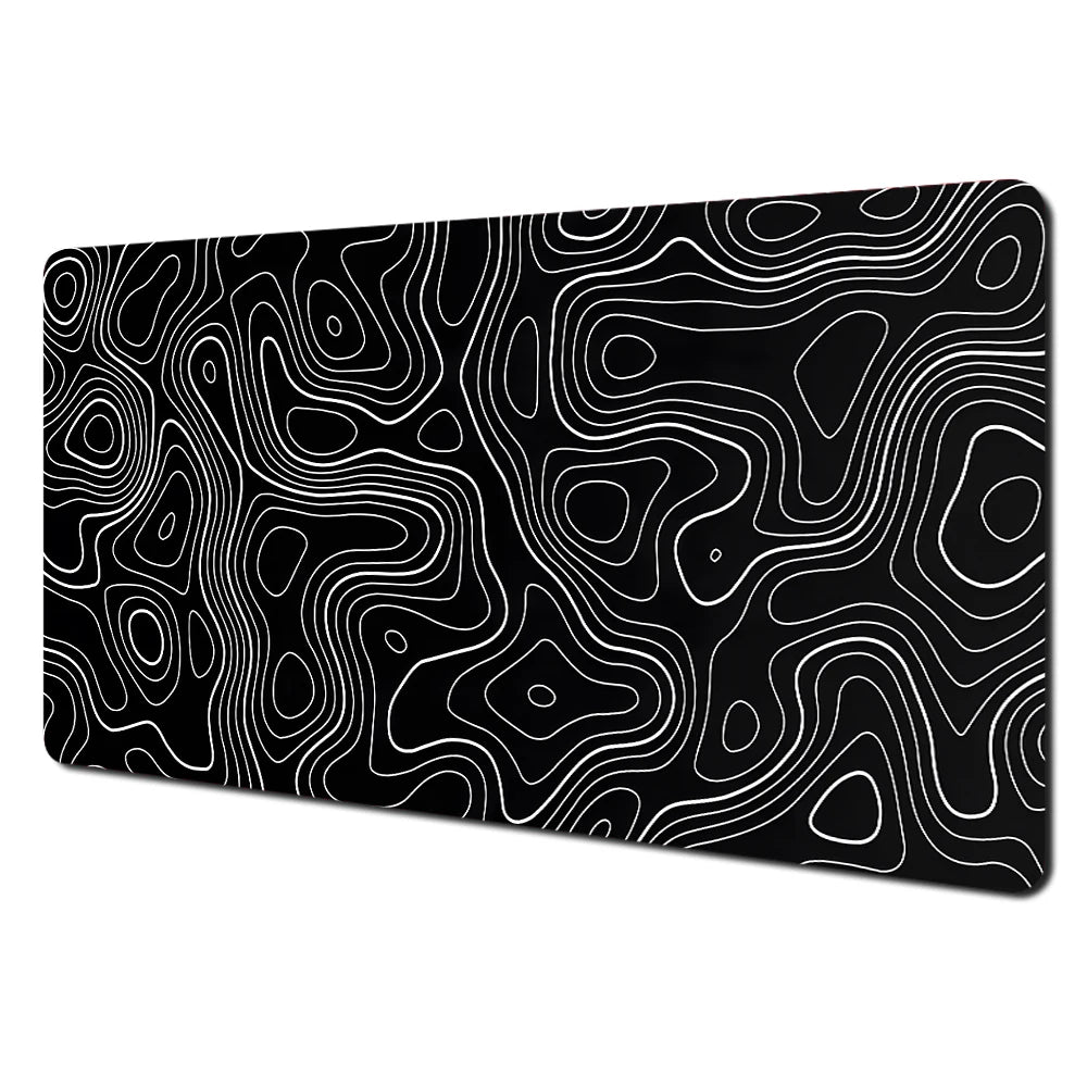 Abstract black and white line art design on a desk mat with a non-slip rubber base