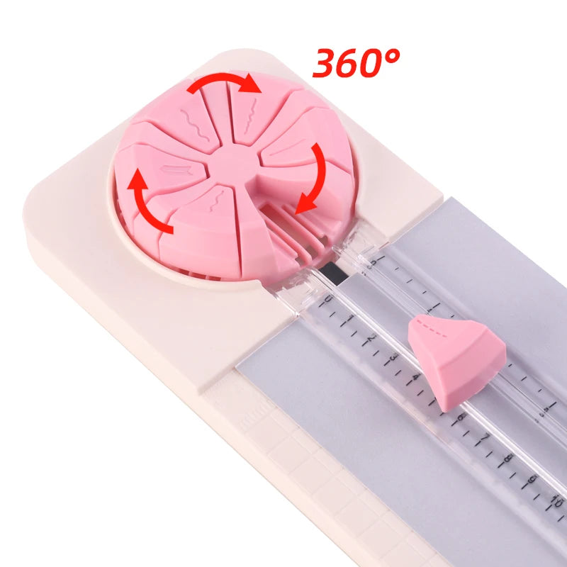 Pink rotary paper cutting machine demonstrating 360 degree cutting capability on a glass slide.