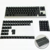 Colección de keycaps de contorno degradado negros para teclado mecánico, mostradas en varios diseños y vistas de cerca.