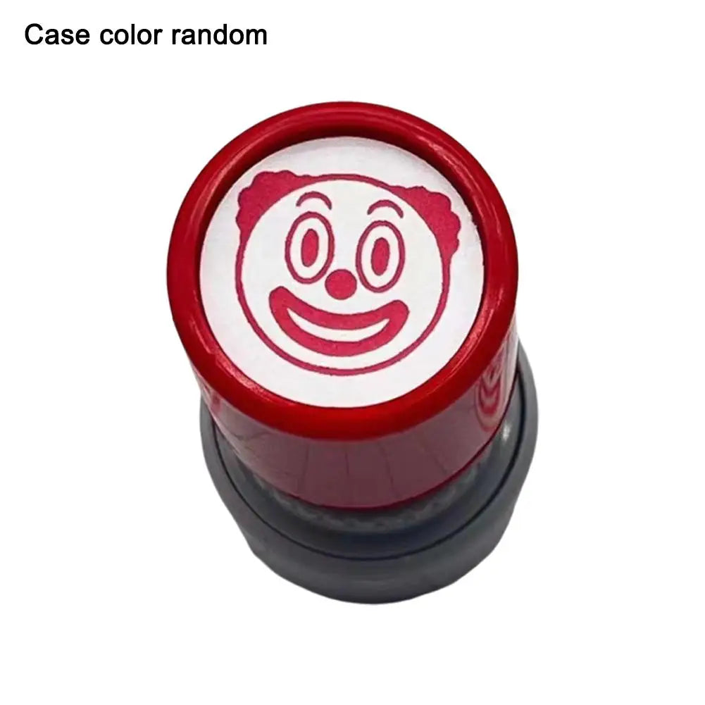 A red rubber stamp with a funny meme face design on the top surface.