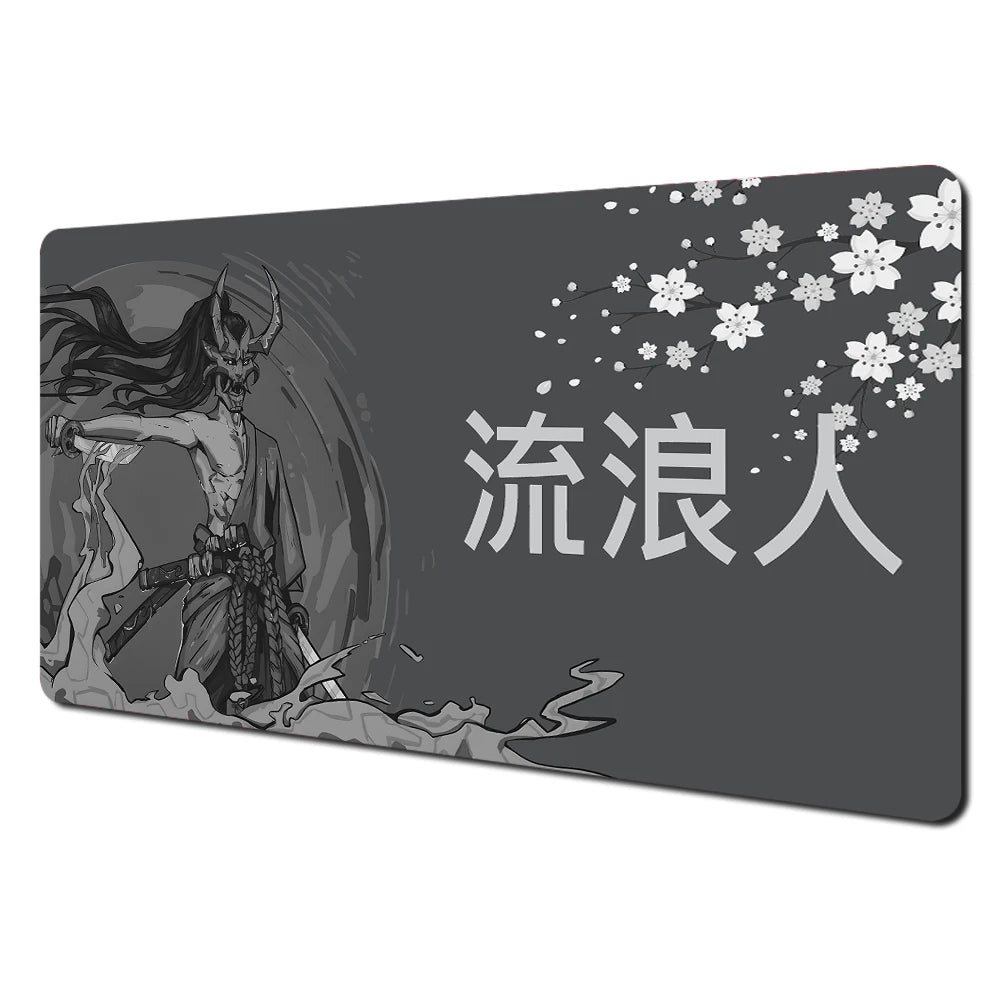 A dark gray desk mat featuring Japanese text and white cherry blossoms.