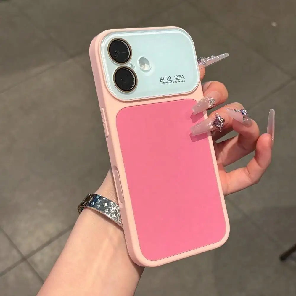 A hand holds a pink color block phone case with full lens protection and decorative nails.