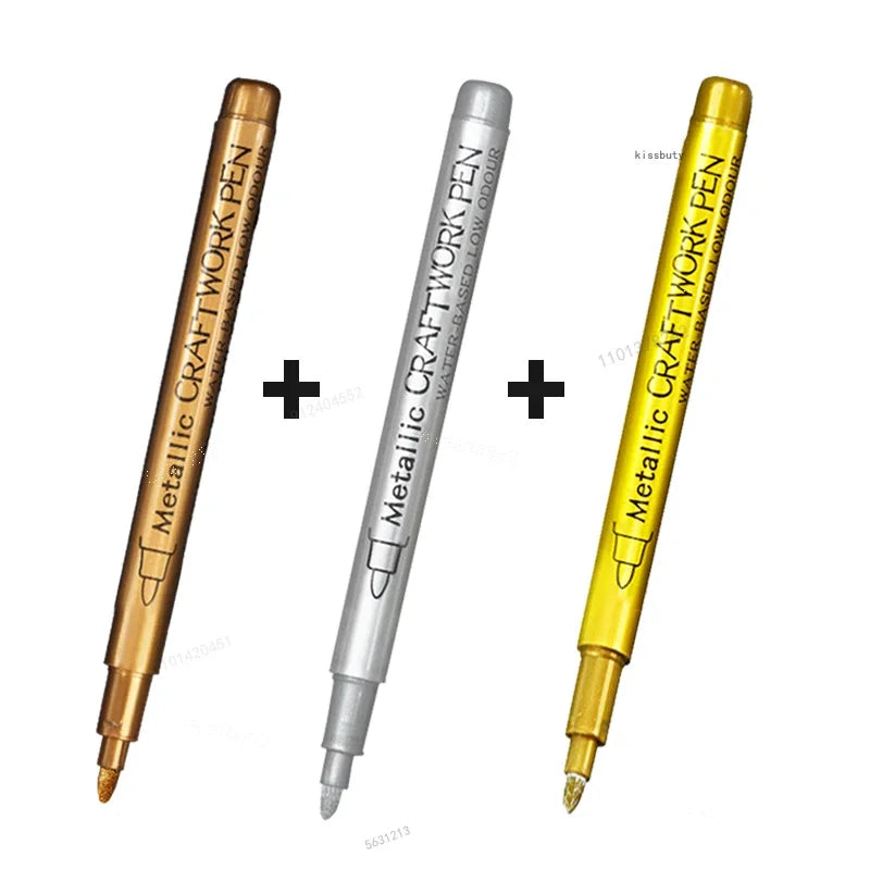 Three metallic brush marker pens in gold, silver, and yellow are displayed side by side.