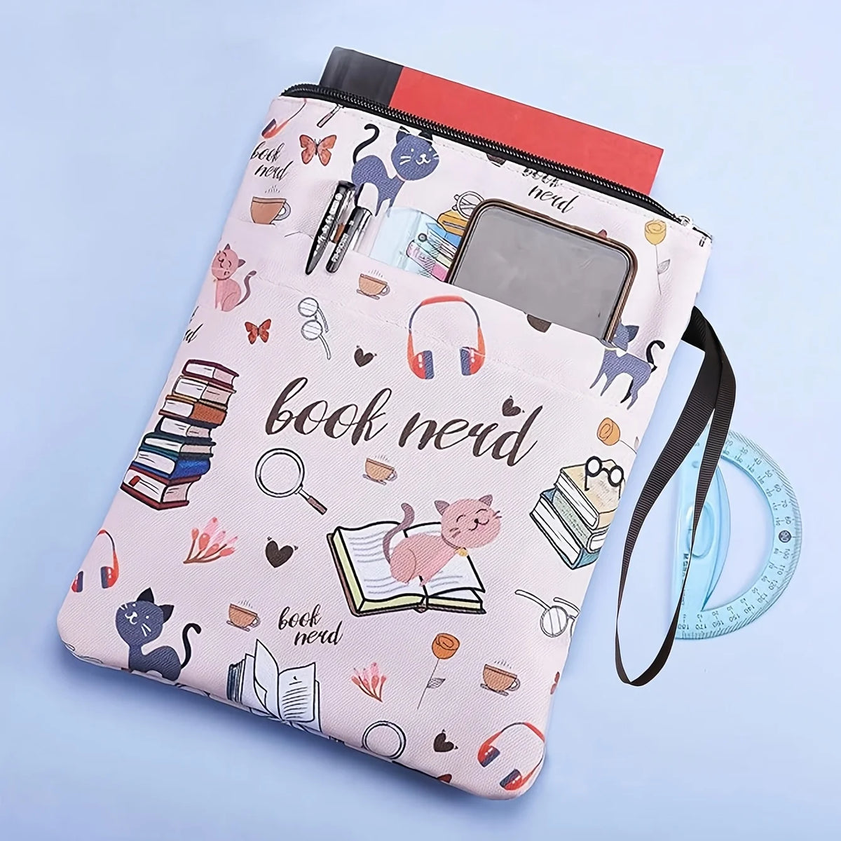 Pink fabric book sleeve with a zipper featuring cat and book lover designs.