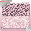 A pink leopard print desk pad featuring a dense pattern of brown and black spots.