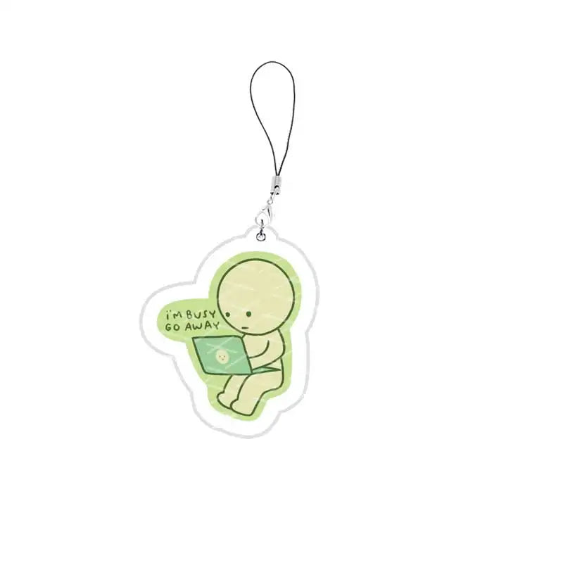 A clear acrylic charm shaped like a person sitting on a laptop, inspired by Smiski, attached to a keychain.