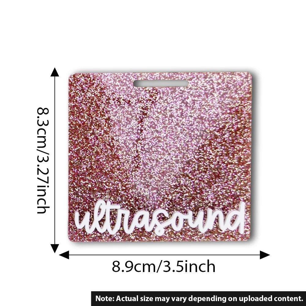 A rectangular, glittery pink acrylic badge holder with the word ultrasound engraved on it.