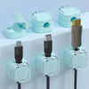 A set of light blue magnetic cable management clips for organizing wires on desks and walls.