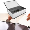 A hand opens a mini dictionary safe for keys and valuables, revealing a compartment inside.