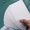 A stack of white watercolor paper cards is shown next to a light blue card holder.