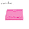 A pink silicone resin mold with various shapes for crafting and DIY projects.