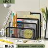 Black metal mesh desk file organizer holding various stationery and a daily planner.