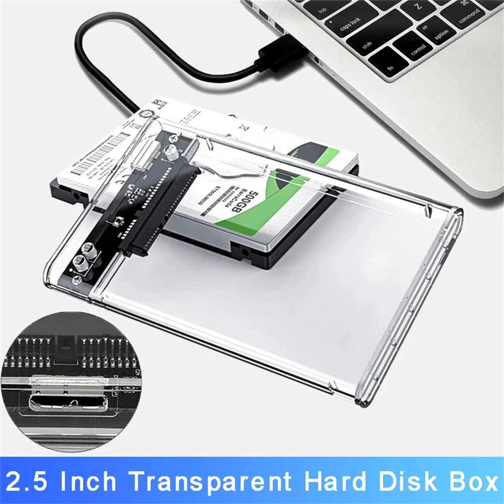 A transparent hard disk box with a removable cover and a SATA drive inside, shown next to a laptop keyboard.