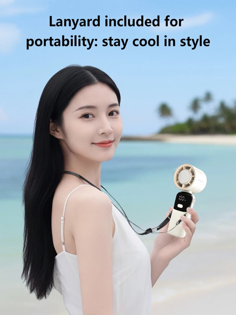 A woman holds a portable rechargeable handheld cooling fan with a lanyard, against a tropical beach background.