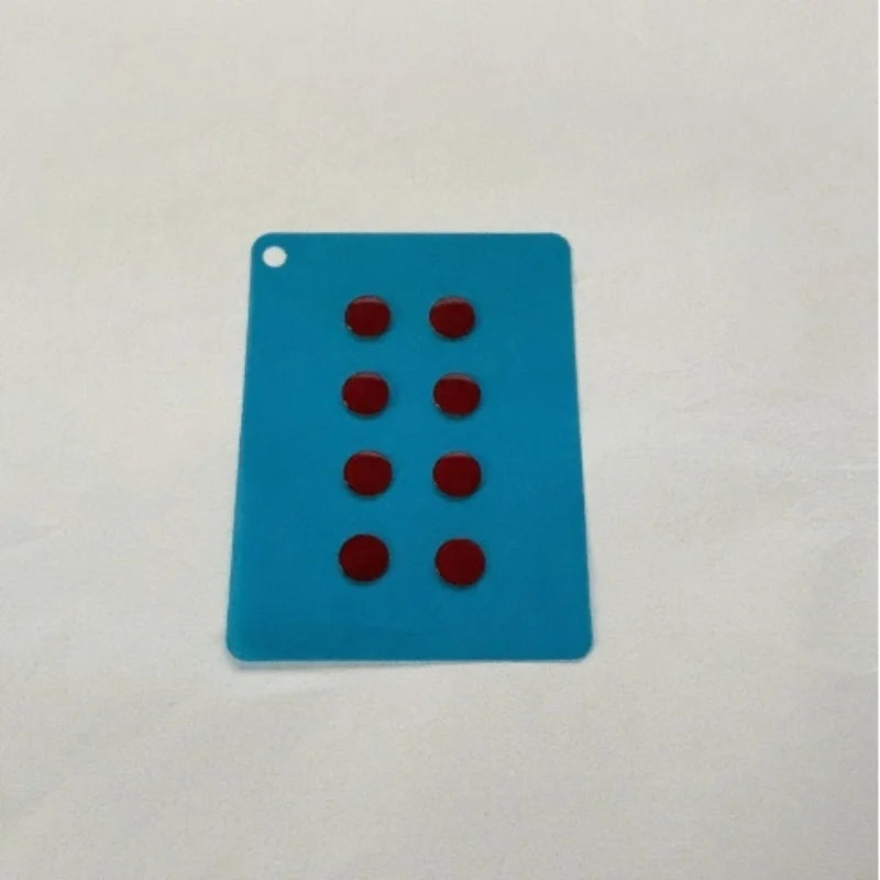 A rectangular blue plastic card with six red circular holes for DIY mouse skates.