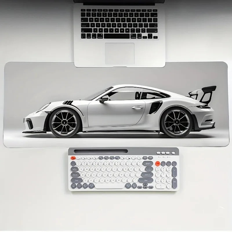 A white sports car is displayed on a gaming mousepad with a laptop and keyboard in the background.