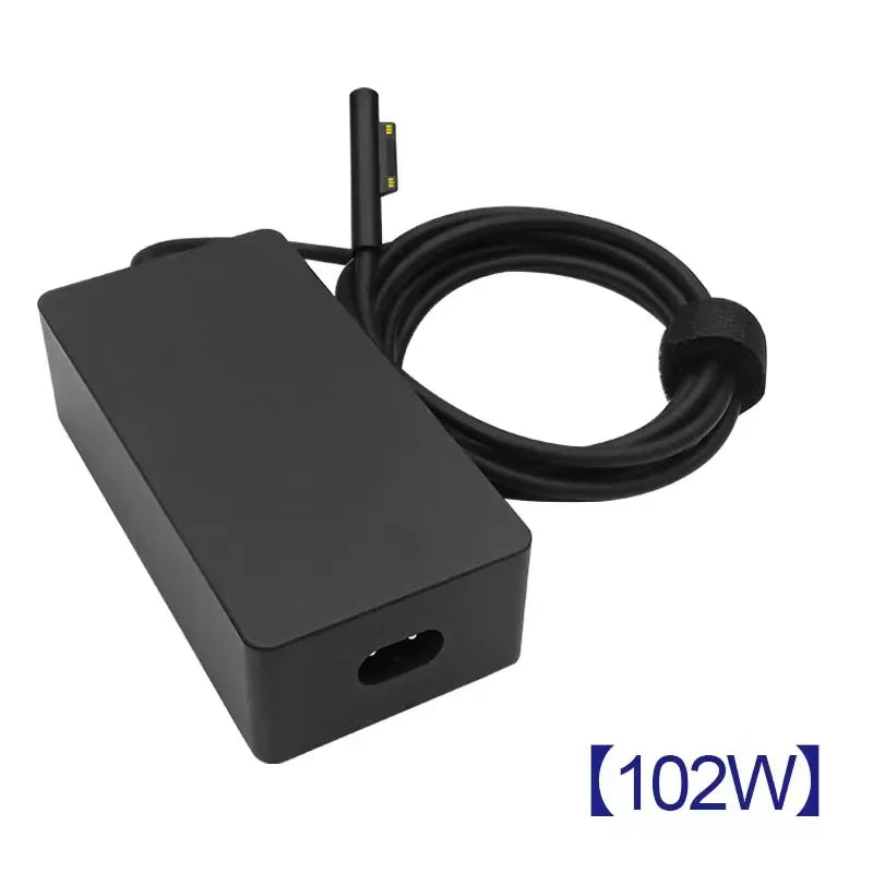 A black universal tablet charger with a coiled cable and a connector for surface devices.