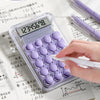 A close-up of a purple silicone keys calculator displaying the number 12345678 on a white background.