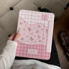 Pink floral print magnetic iPad case with stand featuring a gingham pattern.