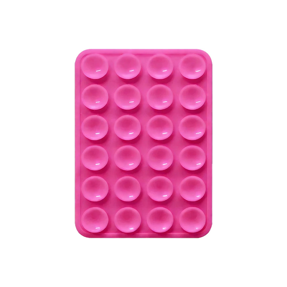 Sujetador de teléfono con ventosa de silicona rosa y múltiples orificios circulares para montar dispositivos.