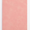 A solid dusty rose colored A5 leather journal or diary.
