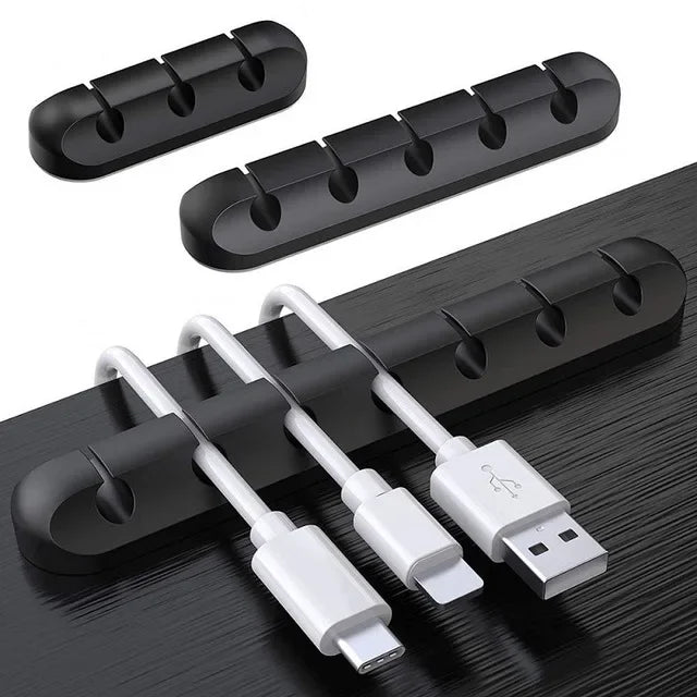 A set of silicone cables and connectors organized in a black plastic holder on a dark surface.