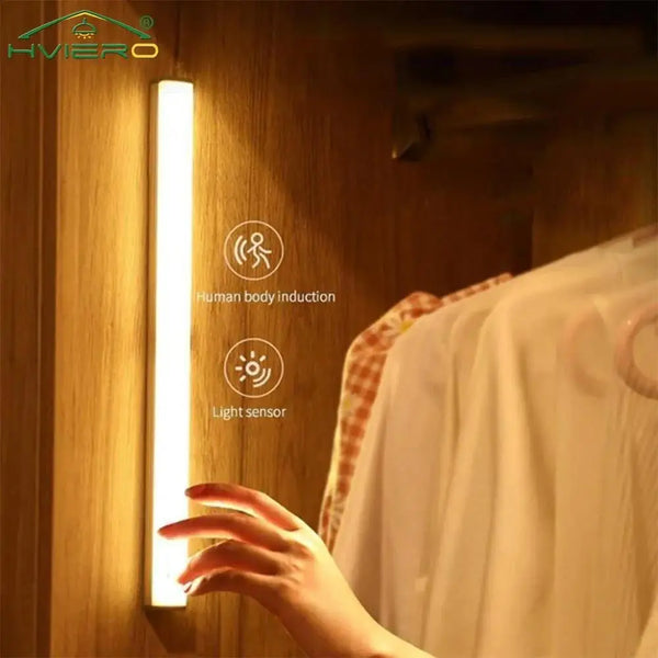 A hand is interacting with a vertical LED light fixture that uses human body induction and a light sensor.