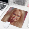 A pink and beige playful doll face mouse pad featuring a realistic blonde woman's expression.