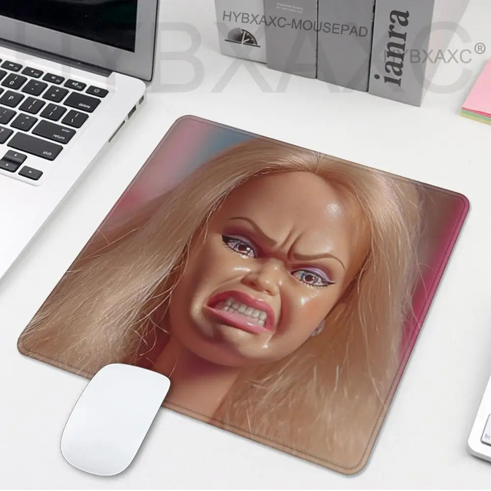 A pink and beige playful doll face mouse pad featuring a realistic blonde woman's expression.