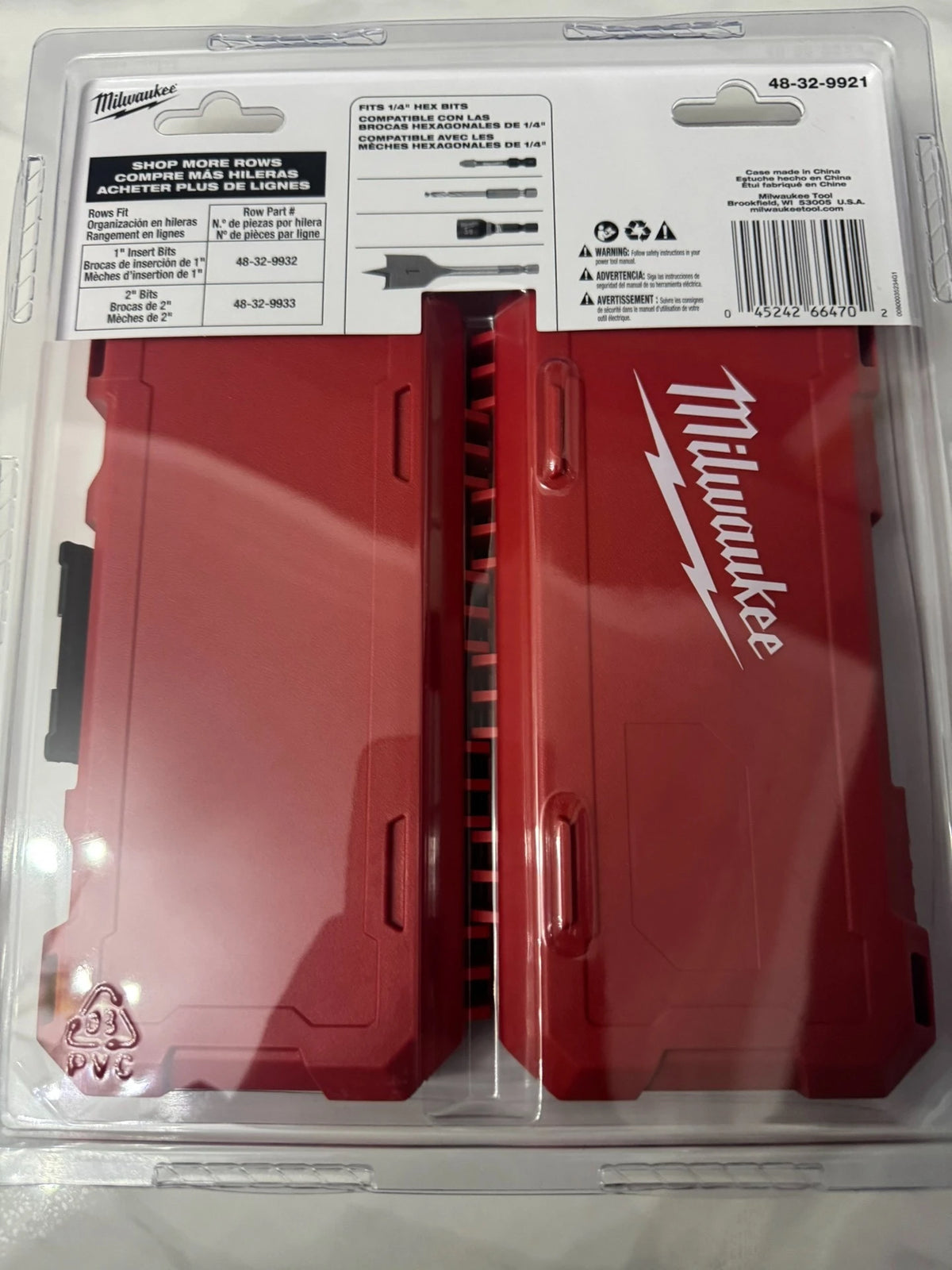 A red Milwaukee bit storage case with a lid and internal organization for various bits.
