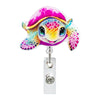 A colorful, smiling, iridescent unicorn-shaped badge reel with a clip attached.